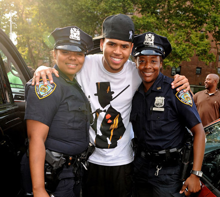 Chris Brown poses with female police officers at Rucker Park