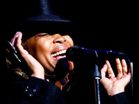 Erykah Badu singing at Roseland, black hat and jacket