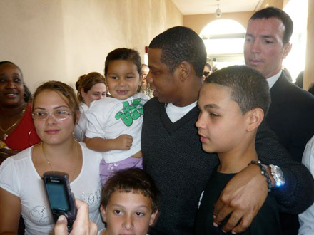Jay-Z cradling a a baby girl on voting line in Florida