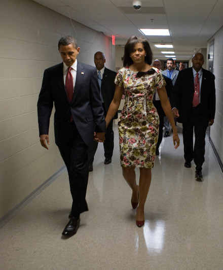 Barack Obama and Michelle Obama walk down the hallway