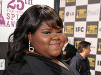 Gabourey Sidibe smiling in a black dress at the Independent Spirit awards
