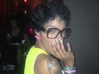 Joseline Hernandez wearing a yellow and green dress and Cazals