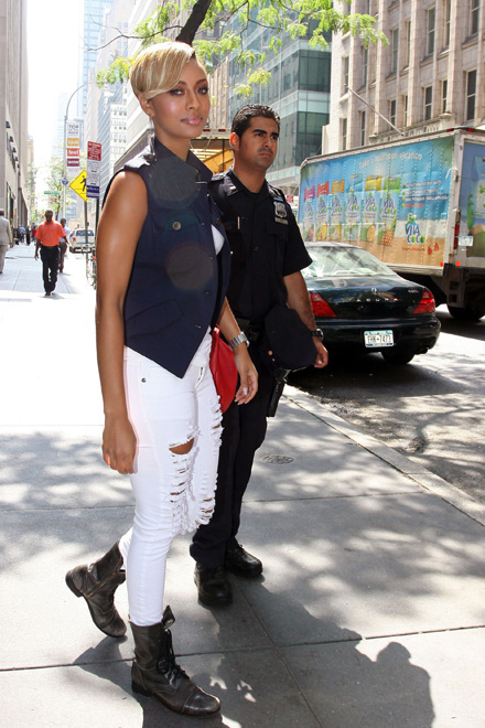 Keri Hilson wearing shredded white jeans and boots in Rockefeller Center