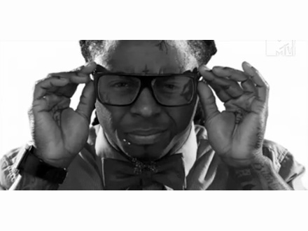 Lil Wayne adjusting his designer glasses.