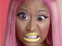 Nicki Minaj with pink hair, big eyes and yellow lipstick
