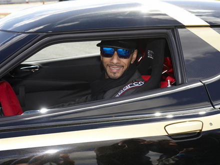 Swizz Beatz smiling in a black Lotus. You would too.