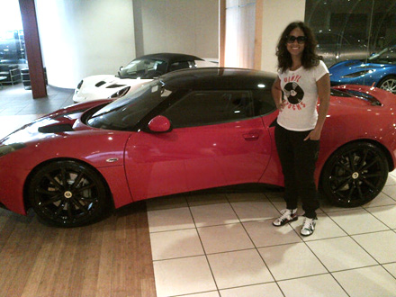 Alicia Keys stands next to her new, red Lotus Evora