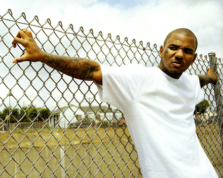 The Game leaning on a fence
