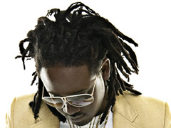 Headshot - T-Pain in a yellow blazer, white shirt, sunglasses and wearing jewelry