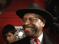 Herman Cain takes questions with a smile