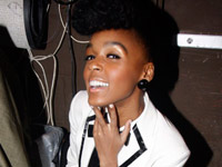 Janelle Monae sitting in her dressing room taking a Poland Spring break.