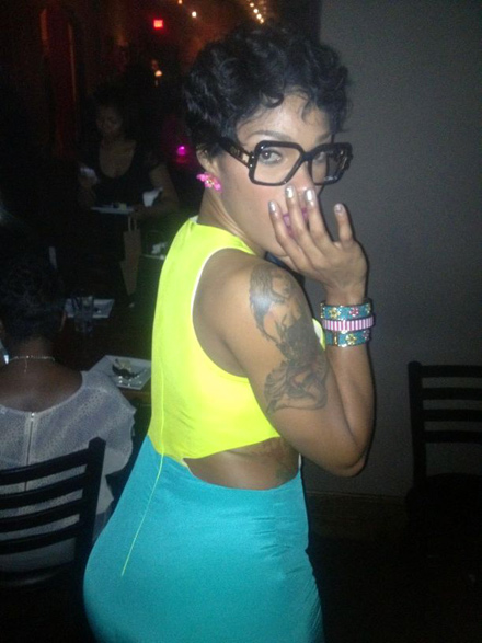 Joseline Hernandez wearing a yellow and green dress and Cazals