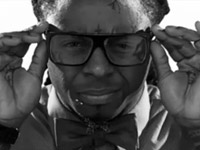 Lil Wayne adjusting his designer glasses.