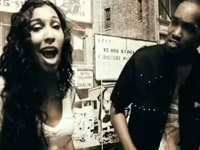 Melanie Fiona singing with a street performer