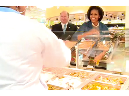 Michelle Obama shakes hand with a supermarket clerk