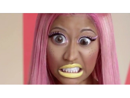 Nicki Minaj with pink hair, big eyes and yellow lipstick
