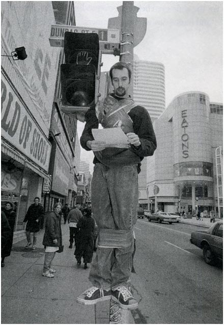 Tom Green strapped to a lightpole