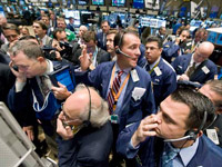 Wall street traders watch as money flows on the monitors