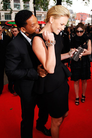 Will Smith bites Charlize Theron's neck at Hancock Premiere in London