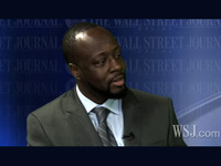 Wyclef Jean in a suit at the Wall Street Journal